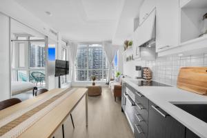 a kitchen with a counter top and a living room at King Bed, Amazing View, Free Parking in Toronto