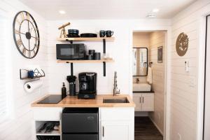 a kitchen with white walls and a counter with a sink at New Starry Night Shipping Container Home in Alpine +23 photos