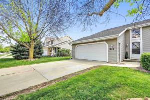 a house with a driveway and a garage at Serene 3 Bedroom Home, NRM, Wi-fi, Parking, Queen Bed in De Pere