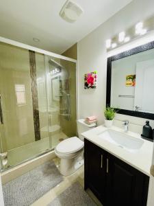 a bathroom with a toilet and a shower and a sink at Homestay- private room and bathroom in Whitby