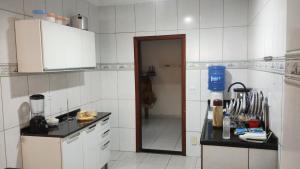 a kitchen with a sink and a counter top at HOSTEL VENDA NOVA in Belo Horizonte