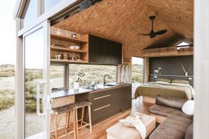 a room with a bed and a kitchen with a sink at EyreWay in Tulka