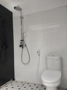 a bathroom with a shower and a toilet in it at Ananda Resort Seminyak in Seminyak