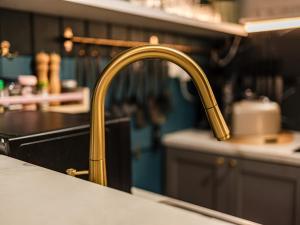 a kitchen sink with a gold kitchen faucet at WB Clare Valley Cottage w Loft in Clare