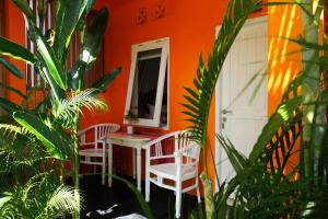 a house with two chairs and a table and a mirror at The Room Padang-Padang in Uluwatu