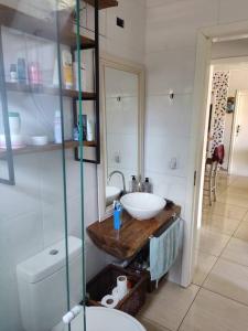 a bathroom with a sink and a toilet at Casa na praia p aproveitar com a família e amigos in Capão da Canoa