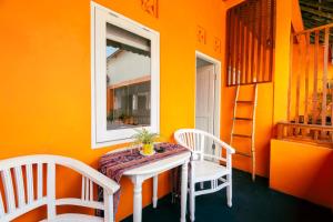 a dining room with a table and two chairs at The Room Padang-Padang in Uluwatu