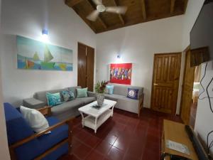 a living room with a couch and a table at Apartamentos Magallanes Bayahibe in Bayahibe