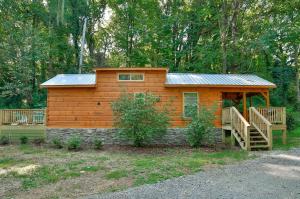 małą drewnianą kabinę z werandą i tarasem w obiekcie Bryce Cabin Lookout Mtn Tiny Home W Swim Spa w mieście Chattanooga