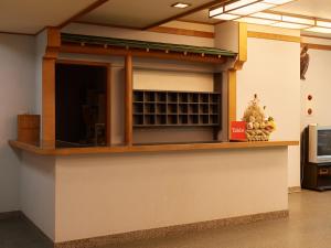 a kitchen with a counter top with a microwave at Tabist Nikkokinugawa Onsen Kiyomizu no Yado in Nikko