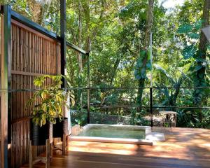 a hot tub sitting on top of a wooden deck at Industrial Studio with private Jacuzzi in Uvita