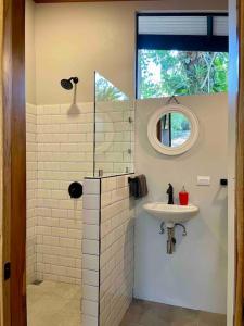een badkamer met een wastafel en een spiegel bij Industrial Studio with private Jacuzzi in Uvita