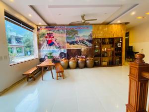 a room with a table and a large poster on the wall at Ba Be Legend Hotel & Tours in Ba Be18