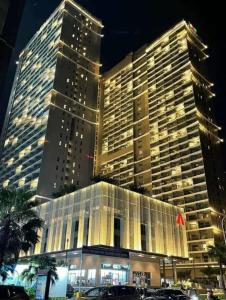 a large building with a large building at night at The Song Vung Tau Near Beach by Hoang Gia in Vung Tau