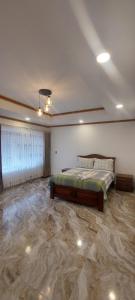 a bedroom with a bed and a marble floor at villa saturia in Ráquira