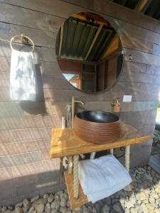 a bathroom with a sink and a mirror on a wall at Vitta Glamping in Rionegro