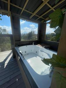 a large bath tub in a room with windows at Vitta Glamping in Rionegro