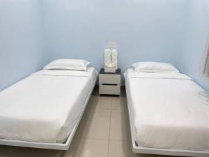 Ein Bett oder Betten in einem Zimmer der Unterkunft Happi Homestay@Taman Saga