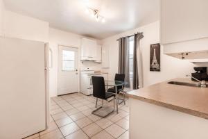 a kitchen and dining room with a table and chairs at 3 bedroom apartment in Verdun in Montreal