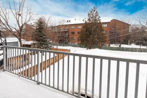 a balcony with a white railing in the snow at 3 bedroom apartment in Verdun in Montreal