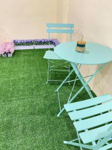a table and two chairs and a table and flowers at Happi Homestay@Taman Saga in Bentong