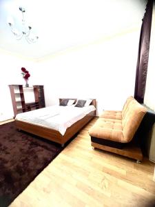 a bedroom with a bed and a couch in it at 215 Рядом с Байтереком для 1-5 чел с 2 большими кроватями и диваном in Astana