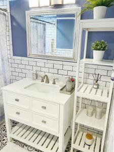 a bathroom with a white sink and a mirror at Casa Agora in St Petersburg