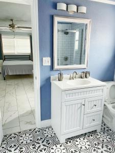 a bathroom with a sink and a mirror and a toilet at Casa Agora in St Petersburg