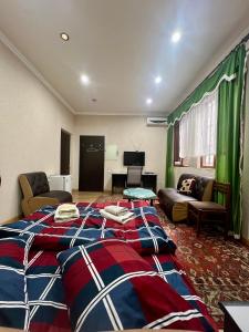 a bedroom with a large bed and a living room at Armenia Guest House in Komitas in Yerevan