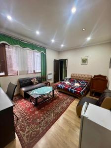 a living room with a couch and a table at Armenia Guest House in Komitas in Yerevan