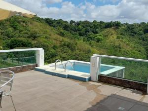 a swimming pool on the deck of a house at Apartamentos Mobiliados in Aldeia