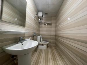 a bathroom with a sink and a toilet at Galaxy Home - Hotel Sky view in Cat Ba