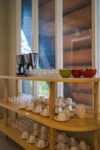 a shelf filled with lots of cups and bowls at Se.nandung Living and Space in Malang