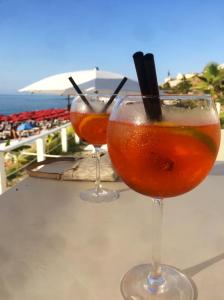 dos copas de vino sentadas en una mesa cerca del océano en Villa with Stunning Sea View Zambrone, en Mandaradoni