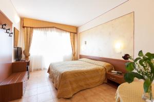 Postel nebo postele na pokoji v ubytování Hotel Fabbrini