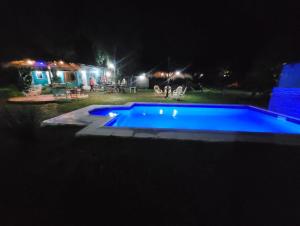 a swimming pool in a yard at night at Pelado Róga in Villa Florida