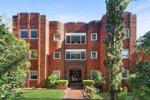 a large red brick building with a courtyard at Stylish & Sunlit Bellevue Hill in Sydney