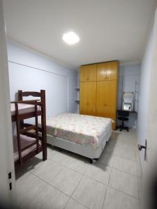 a bedroom with a bed and a desk in it at Cobertura Vista Para o Mar Praia Boraceia-SP Litoral Norte in Boracéia
