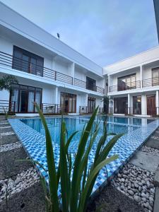 an exterior view of a building with a swimming pool at Haven Suites Siargao in General Luna