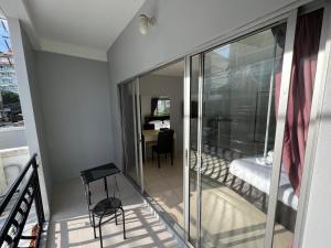 a glass balcony with a chair and a desk at Beach&hills in Pattaya South