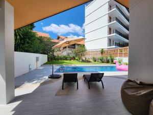 an external view of a house with a swimming pool at PoolVilla 234 Patong in Patong Beach