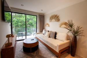 a living room with a couch and a large window at Nowness in Mexico City +282 photos