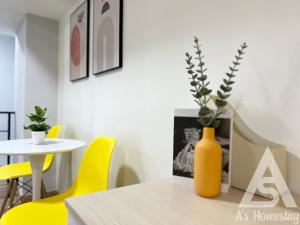 a table with yellow chairs and a vase on it at Arte Cheras Romantic MRT Cheras Wi-Fi Smart Tv AsHome in Kuala Lumpur