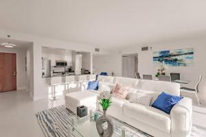 a white living room with a white couch and a table at Upscale Brickell 2 bedroom with water views and free parking in Miami