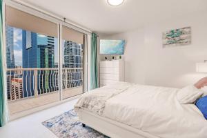 a bedroom with a large window with a city view at Upscale Brickell 2 bedroom with water views and free parking in Miami