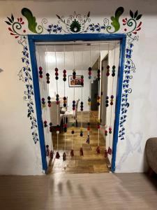 a room with a door with a bunch of ornaments at AITANA'S HOUSE - SAN BLAs in Cusco