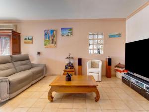 ein Wohnzimmer mit einem Sofa und einem Couchtisch in der Unterkunft Villa with swimming pool in Sorgues in Sorgues