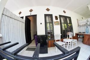 a room with a table and chairs in a room at Jepun Villas 08 - One Bedroom with 3 beds and kitchen in Uluwatu