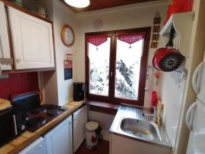 a small kitchen with a sink and a window at Chalet La Clusaz, 5 pièces, 6 personnes - FR-1-459-129 in La Clusaz