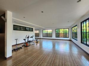 a large room with a gym with treadmills and windows at Cordelia Resort Sam Roi Yot in Sam Roi Yot